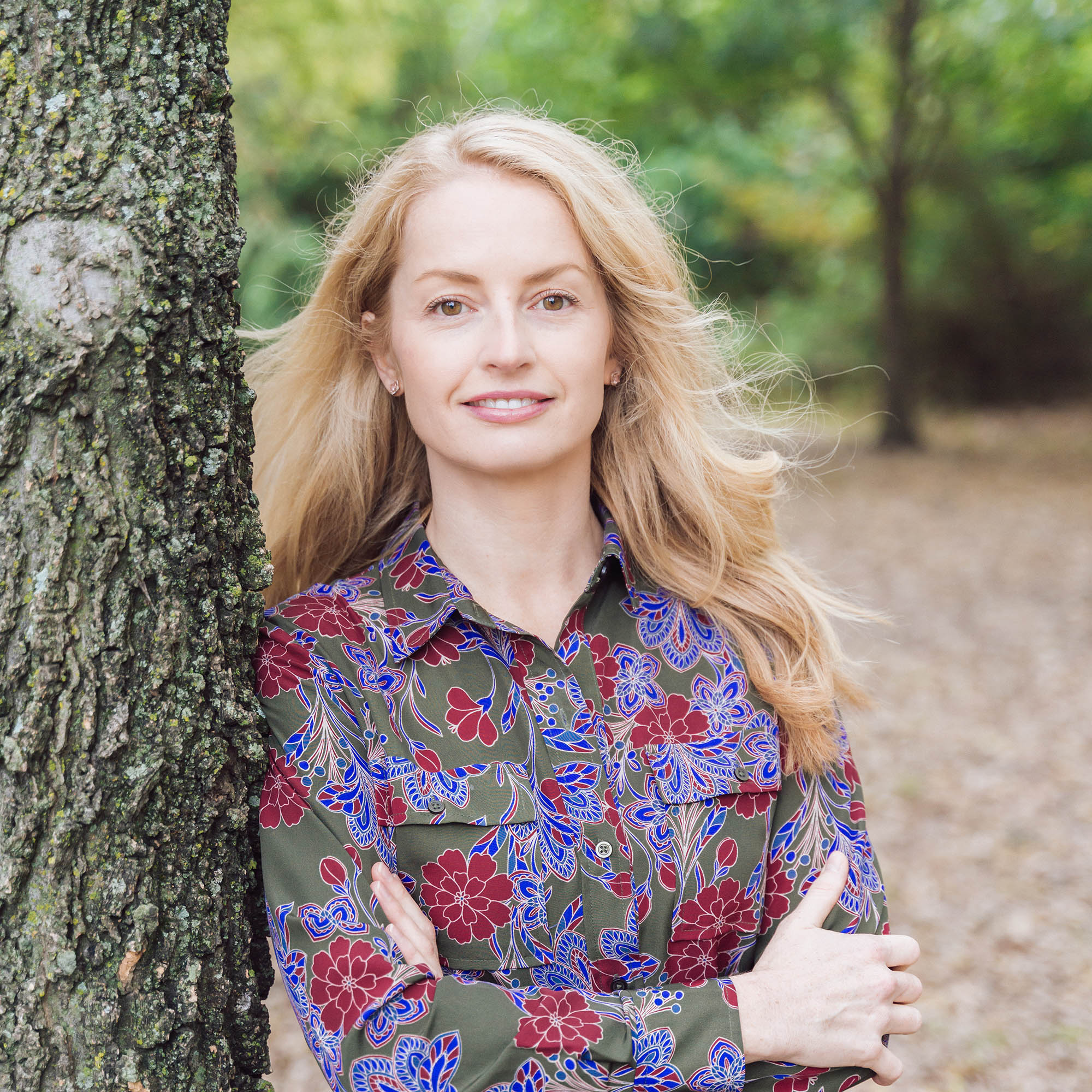 Janine leaning on a tree