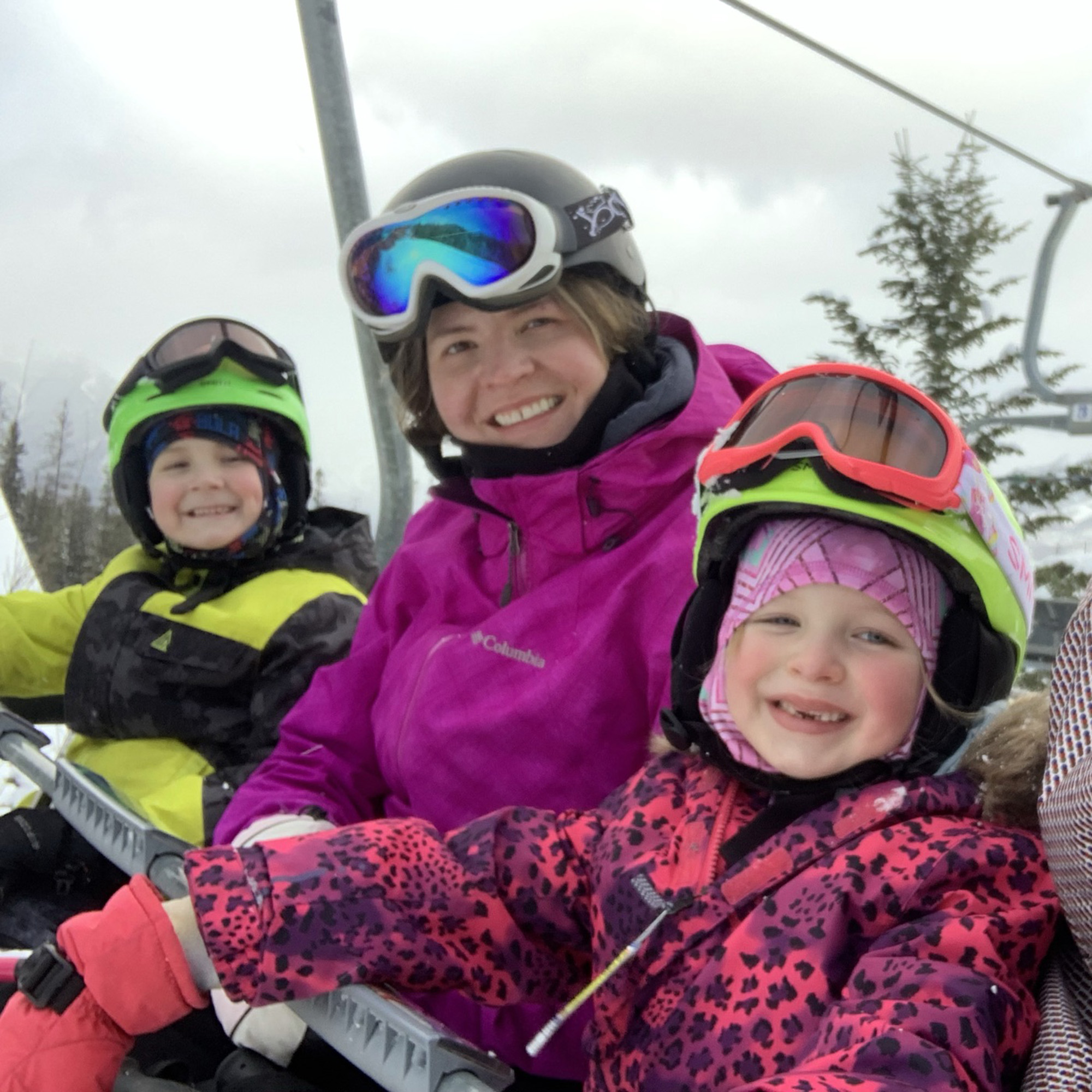 Jo and her kids on a chairlift while skiing